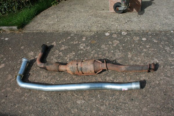 The new de-cat exhaust pipe next to the old pipe