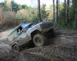 Which Land Rover to take off roading? Final Result! Land Rover Defender spinning its wheels up a muddy hill