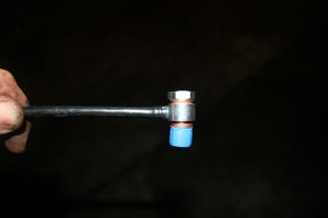 The new breather with protective plastic cap covering the threads