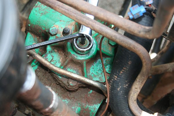 Use a spanner to undo the lock nut, and an allen key to adjust the steering play