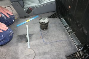 Marking out where to cut the carpet - using a tub to give the curved edges