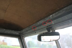 The location some of the bolts holding the truck cab to the windscreen