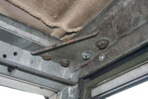 The corner bracket secures the windscreen to the over door drain channel