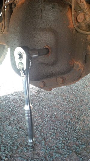 Use a half inch drive ratchet to undo the filler plug