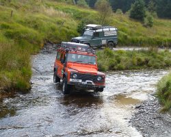 Discovering the green lanes of Wales by Land Rover G4 Defender on a water crossing